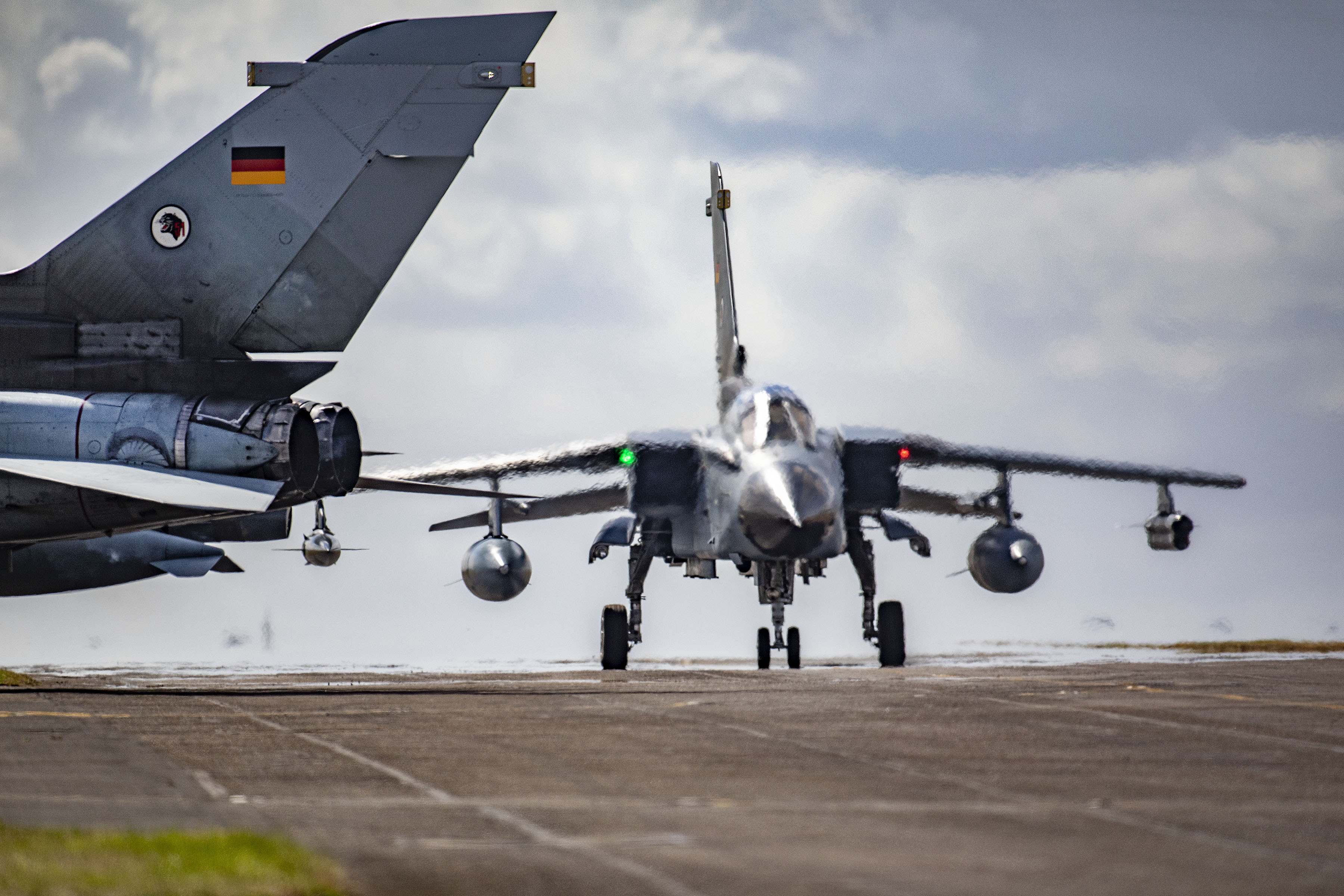Image shows fighter jets on the runway.